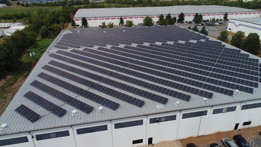 Aerial view of a commercial rooftop solar installation.